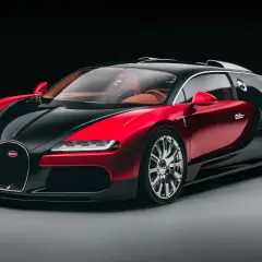 Elegancki Bugatti Veyron w dwukolorowej czerwono-czarnej karoserii, z luksusowym, brązowym wnętrzem. To ikona wśród bugatti modele.