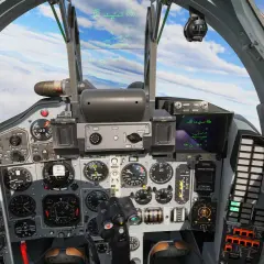 Widok z kokpitu myśliwca Mig-29. Wiele wskaźników i ekranów wyświetla dane lotu.