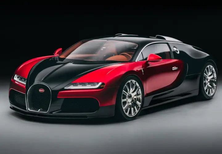 Elegancki Bugatti Veyron w dwukolorowej czerwono-czarnej karoserii, z luksusowym, brązowym wnętrzem. To ikona wśród bugatti modele.