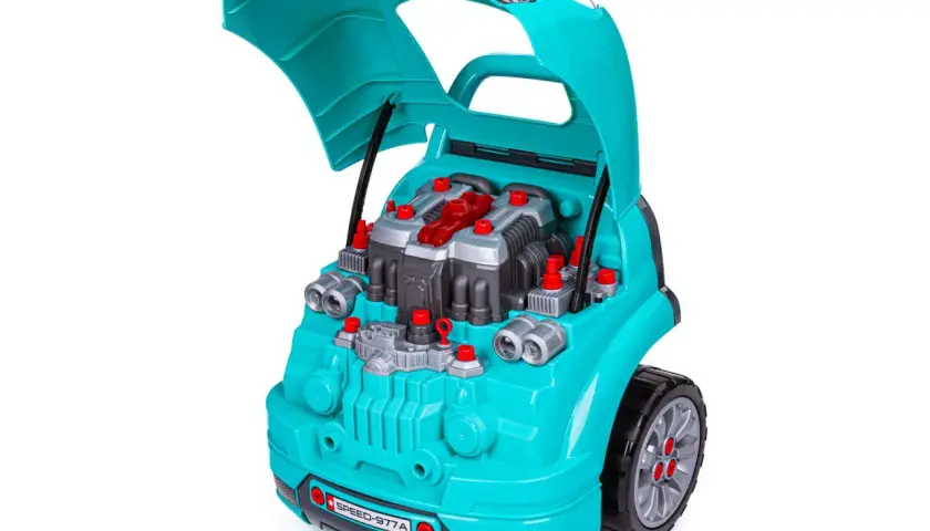 Turkusowy **zestaw małego mechanika** z otwartą maską, ukazujący plastikowy silnik z czerwonymi elementami i śrubami.