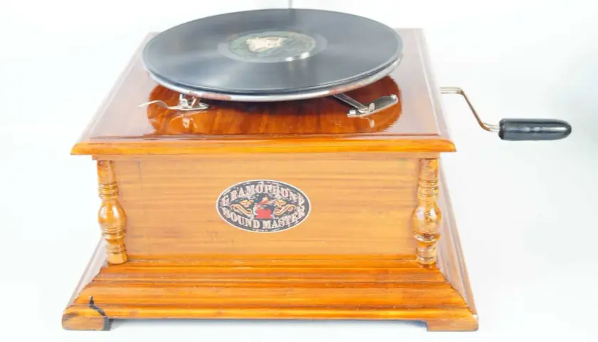 Elegancki gramofon drewniany z korbką i płytą.