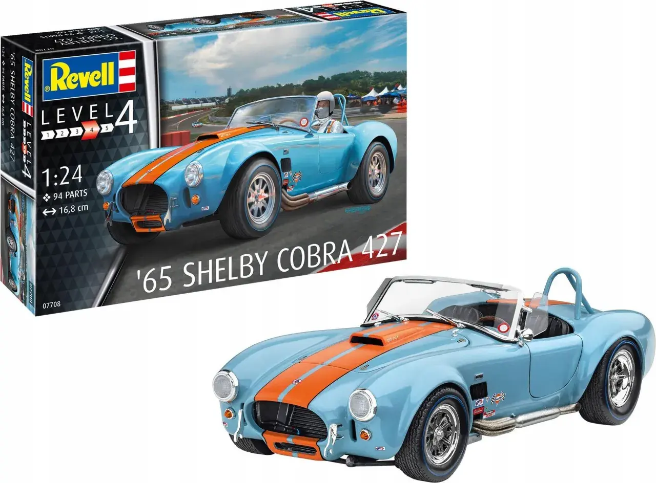 Niebieski model samochodu '65 Shelby Cobra 427 z pomarańczowymi pasami, obok pudełka z modelem Revell.