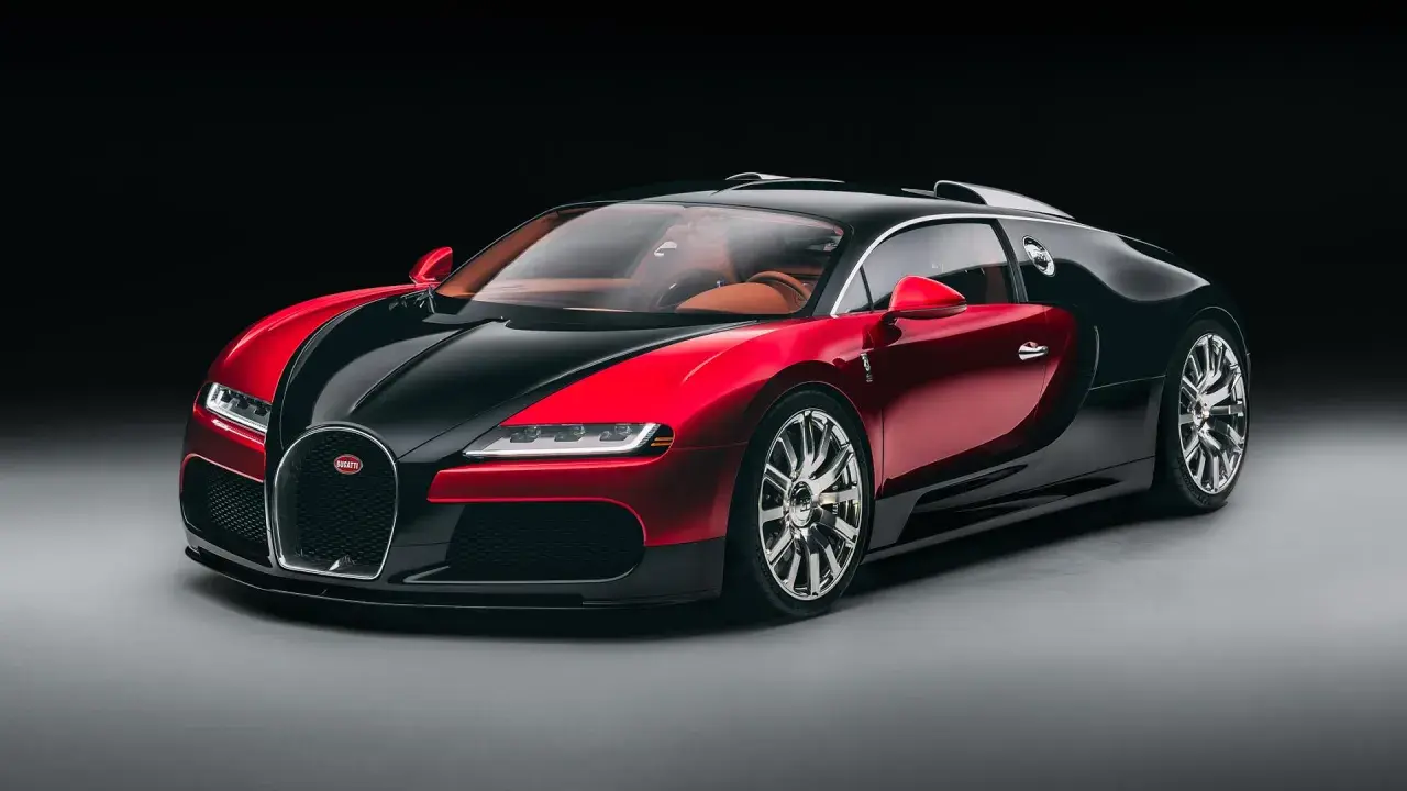 Elegancki Bugatti Veyron w dwukolorowej czerwono-czarnej karoserii, z luksusowym, brązowym wnętrzem. To ikona wśród bugatti modele.