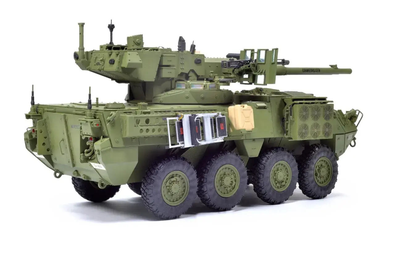 M1128 Stryker, zielony pojazd opancerzony z wieżyczką, działkiem i karabinem maszynowym, gotowy do akcji.